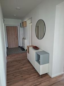 a white room with a mirror and a dresser at Apartmá 575 in Strakonice