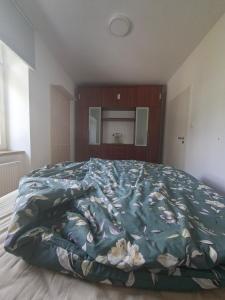 a bedroom with a large bed with a blue comforter at Apartmá 575 in Strakonice +1 photo