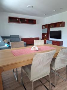 a dining room table with chairs and a couch at Apartmá 575 in Strakonice
