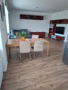 a living room with a wooden table and chairs at Apartmá 575 in Strakonice