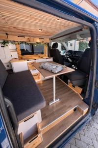 a van with a table in the back of it at La Vallena Camper in Madrid