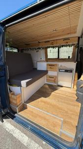 an open back of a van with a table in it at La Vallena Camper in Madrid