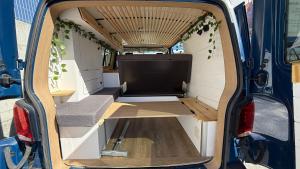 an open back of a van with a tv in it at La Vallena Camper in Madrid