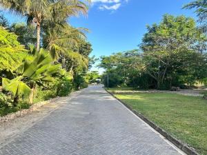 a cobblestone road with palm trees on either side at Didas Villa Zanzibar in Zanzibar City
