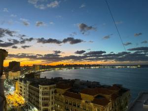 a view of the water from a building at sunset at New Hyde Park House Hotel in Alexandria