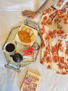 a tray with a plate of food and a cup of coffee at New Hyde Park House Hotel in Alexandria