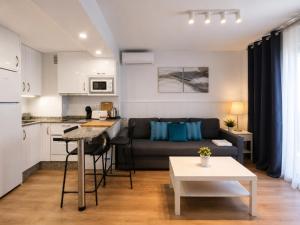 a living room with a couch and a table at Ocean House Costa del Sol apartamentos varios by Costa del Sol Stay in Torremolinos