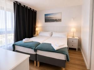a bedroom with two beds and a window at Ocean House Costa del Sol apartamentos varios by Costa del Sol Stay in Torremolinos +19 photos