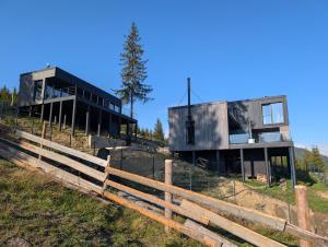 a house on top of a hill with a fence at Mountain air Horishnii in Palyanytsya