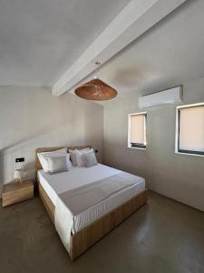 a bedroom with a large bed and a light at Villa Eden in Kallithea Halkidikis +22 photos
