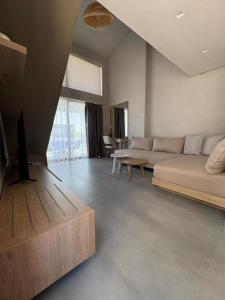 a living room with a couch and a table at Villa Eden in Kallithea Halkidikis