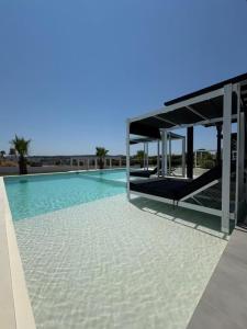 a large swimming pool with a building in the background at Villa Eden in Kallithea Halkidikis