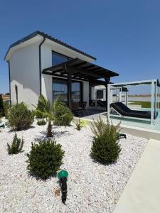 a house with a landscaping with plants in front of it at Villa Eden in Kallithea Halkidikis