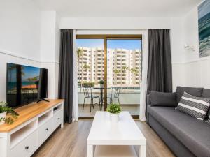 a living room with a couch and a tv at Ocean House Costa del Sol apartamentos varios by Costa del Sol Stay in Torremolinos