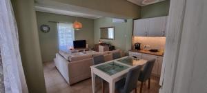 a living room with a couch and a table at Andros house in Andros