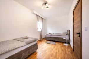 a bedroom with two beds and a window at New Modern Apartments with Private Parking in Leštane