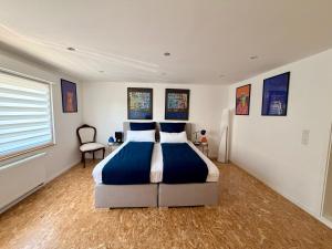 a bedroom with a bed and a chair in it at Hermelsstübche in Siegen