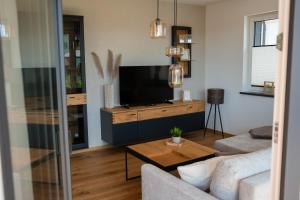 a living room with a couch and a tv at LOFT 21 Rhön in Hofbieber