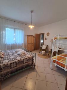 a bedroom with two bunk beds and a living room at Agriturismo Bellavista in Arsita