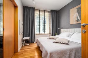 a bedroom with a large bed and a window at Chmielna, Sun&Snow in Warsaw