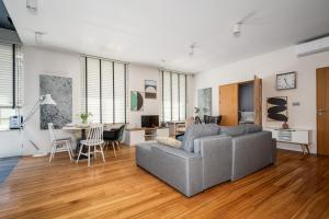 a living room with a couch and a table at Chmielna, Sun&Snow in Warsaw