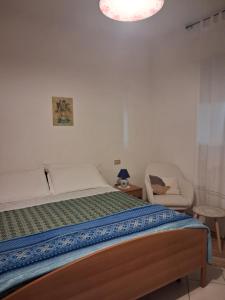 a bedroom with a bed and a chair at Agriturismo Bellavista in Arsita +25 photos