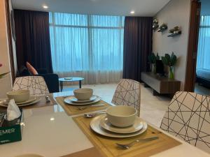a dining room and living room with a table and chairs at VORTEX Suites KLCC Premium BY RRP in Kuala Lumpur
