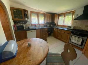 a kitchen with a wooden table and a wooden counter top at BLTN House in Balatonalmádi