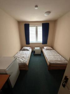 a room with two beds and a window at Ubytovna E75 in Mosty u Jablunkova