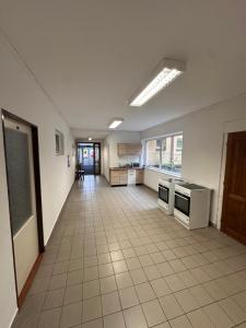 an empty room with a kitchen and a hallway at Ubytovna E75 in Mosty u Jablunkova