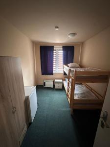 a room with two bunk beds and a window at Ubytovna E75 in Mosty u Jablunkova