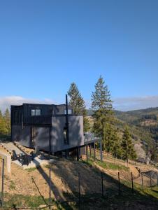 a black house on top of a hill at Mountain air Legit in Palyanytsya