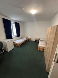 an empty room with two beds and a desk at Ubytovna E75 in Mosty u Jablunkova