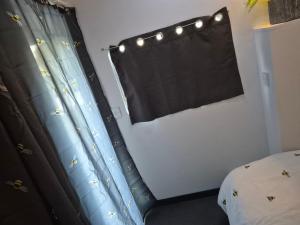 a bedroom with a bed and a black curtain at Wake up with Wallabies in Par