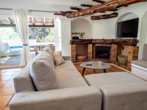 a living room with a couch and a fireplace at El Charco in Cala Llonga