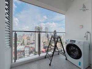 a washing machine in a room with a large window at Le Conde Maison in Phnom Penh