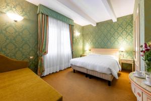 a bedroom with a white bed and a window at Hotel Villa Delle Palme in Venice-Lido +77 photos