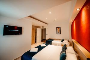 a room with two beds and a tv on the wall at Vila Diamond in Saturn