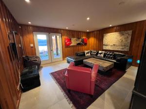 a living room with a couch and a table at Mont-Tremblant Mountain View Chalet in Lac-Superieur