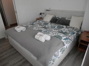 a bedroom with a bed with towels on it at Aloha Benidorm in Cala de Finestrat +21 photos