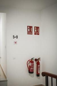 a wall with two fire hydrants on a wall at Suites Puerta Doñana in Hinojos