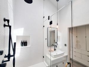 a white bathroom with a sink and a mirror at Private Venice Beach Luxury Bungalow, Outdoor Tub, Steps To Ocean & Abbot Kinney in Los Angeles +75 photos