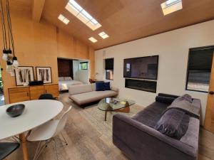 a living room with a couch and a table at Private Venice Beach Luxury Bungalow, Outdoor Tub, Steps To Ocean & Abbot Kinney in Los Angeles
