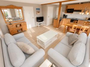 a living room with a couch and a table at Bauernhaus 3 -Vaest- in Fehmarn