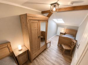 a room with a bed and a wooden door at Bauernhaus 3 -Vaest- in Fehmarn +13 photos