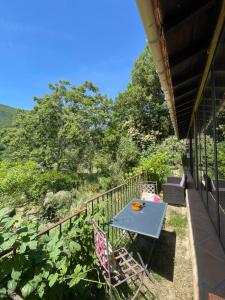 a table and chairs on the porch of a house at DOMAINE St GEORGES in Mosset