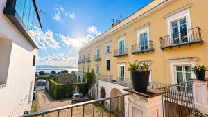a balcony of a building with potted plants on it at Hotel Terme Neronensis in Pozzuoli