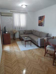 a living room with a couch and a table at Jana apartment 3 in Tivat