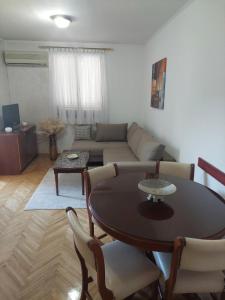 a living room with a table and a couch at Jana apartment 3 in Tivat