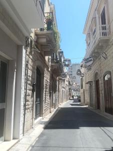 an empty street with buildings on either side at B&B Liberty in Andria